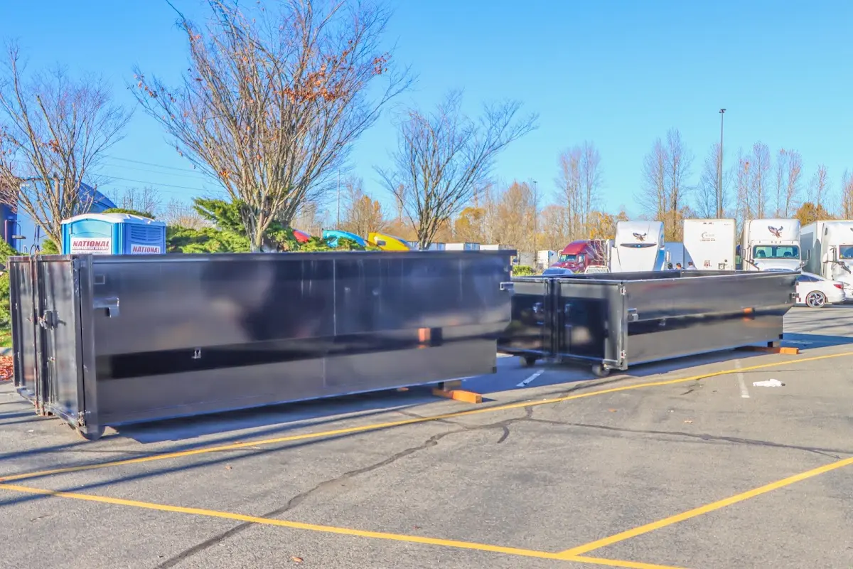 Professional dumpster rental service with roll-off container on residential driveway in Solvay